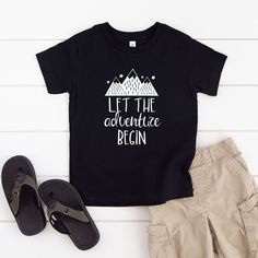 Looking for a cute tee for your kids? We have the perfect Let The Adventure Begin Mountains graphic tee addition to their closet! Also available in toddler tees. Black Graphic Print T-shirt For Adventure, Cute Black T-shirt With Funny Text, Black Cotton T-shirt For Adventure, Black Graphic Tee For Adventure, Mountains Graphic, Mountain Graphic Tee, Vans Toddler, Let The Adventure Begin, Retro Shorts