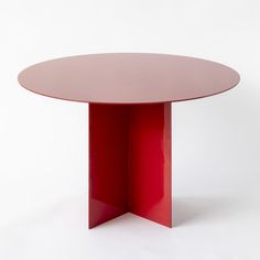 a round table with a red base against a white background