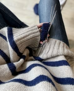 a person sitting on the floor with their legs crossed