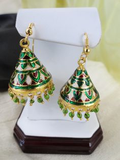 Indian minakari dangling "jhumki" earrings. Meenakari, also called enamelling, is the art of decorating a metal surface by fusing mineral substances to it. Meenakari was introduced to India by the Mughal kings in the early 16th century. So, this delicately designed ear ring comes from workmanship which dates back to some 400 hundred years.The meenakari work is very similar in craftsmanship to the miniature design and coloring on the famous Faberge eggs. The design is etched into the metal and th Traditional Green Teardrop Jewelry, Green Latkans Danglers For Celebration, Green Danglers With Latkans For Celebration, Meenakari Enamel Jewelry, Green Latkans Earrings For Diwali, Metal Jhumkas Drop Earrings For Gifts, Green Drop Jhumkas For Festivals, Meenakari Earrings As Gift, Meenakari Earrings For Gift