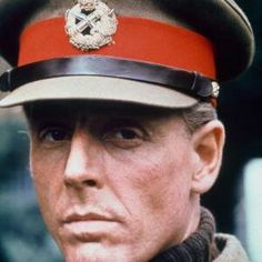 a man in uniform is looking at the camera with an intense look on his face