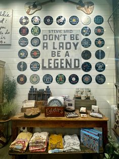 a store display with lots of items on the wall and signs above it that say don't be a lady, be a legend