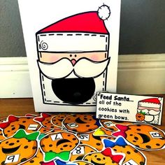 a christmas card with cookies and santa's hat next to it on the floor