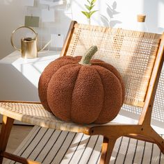 a large pumpkin sitting on top of a wooden chair