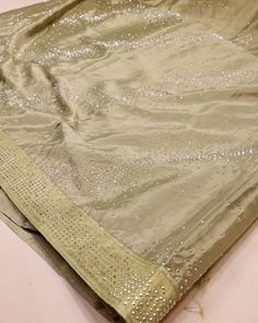 A stunning sage green chiffon saree with beading that can be perfect for any event (receptions, formals, parties, etc.)! This transparent piece has that silky body-hugging effect due to the light weight chiffon material. Blouse material is included (last image) and this saree can also be purchased in baby pink or baby blue! Elegant Pista Green Dola Silk Pre-draped Saree, Green Organza Saree For Party, Green Organza Party Saree, Green Tissue Silk Saree For Party, Green Dola Silk Saree For Party, Embellished Green Georgette Saree, Green Chinon Party Wear Dupatta, Party Green Dola Silk Saree, Bollywood Style Pista Green Blouse For Party