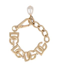 Gold tone brass-blend logo-lettering bracelet from DOLCE & GABBANA featuring logo lettering, chain-link detailing, pearl detail, adjustable fit and lobster claw fastening. | Dolce & Gabbana Logo-Lettering Bracelet Designer Gold-tone Metal Jewelry, Metal Bracelet With Logo Charm, Designer Gold Bracelets With Logo Charm, Designer Gold-tone Logo Bracelets As Gift, Elegant Metal Chain Bracelet With Logo Charm, Gold-tone Metal Bracelets With Logo Charm, Gold-tone Bracelet With Logo Charm, Designer Metal Chain Bracelets, Luxury Gold-tone Jewelry With Logo Lettering