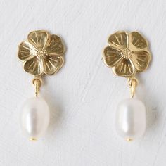 A sweet pair of small golden brass flower studs with 5mm freshwater pearls. Size | 10mm flowers, 5mm pearls Material | 24K gold plated posts, freshwater pearls (high quality), brass flower Good to Know | Handmade with ethically sourced, fair trade materials by Nest Pretty things in Burlington, VT. $26.00 per pair Burlington Vt, Daily Jewelry, Good To Know, Flower Studs, Pearl Studs, Heart Jewelry, Pretty Hairstyles, Pretty Things, Fair Trade