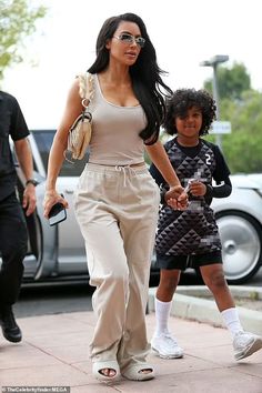 the mother and daughter are walking down the street