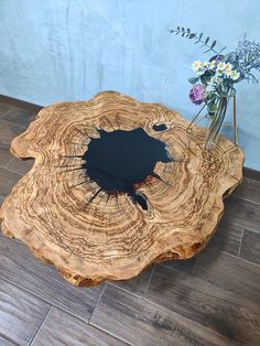 a wooden table with a flower vase on it