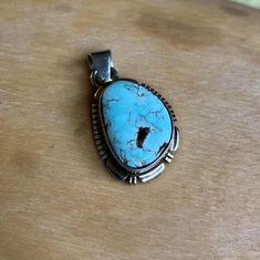 This vintage Small Navajo Sterling silver pendant features a rare high polish Dry Creek turquoise with its symbolic rare pastel blue natural color. Fine and delicate.  Swipe to see picture for pendant measurement, compare to quarter coin. Weight: 4.1 grams Signed: JF Sterling Dry Creek Turquoise comes from a small Turquoise mine outside of Austin, Nevada in Lander County. This mine was previously known for its sky blue to medium blue webbed turquoise. Dry Creek Turquoise has gained much popularity over the years with its creamy pale blue coloring and golden to cocoa brown matrix. This color of Turquoise was rarely used in Turquoise Jewelry before the late 1990s. The color is a pastel blue much like the color of Larimar, only high grade Dry Creek Turquoise has beautiful light brown, golden Untreated Oval Turquoise Necklace In Bohemian Style, Southwestern Turquoise Necklace With Large Round Pendant, Artisan Blue Turquoise Necklace Untreated, Untreated Turquoise Pendant Necklace For Collectors, Untreated Bohemian Turquoise Necklace For Collectors, Bohemian Untreated Oval Turquoise Necklace, Untreated Oval Blue Turquoise Necklace, Southwestern Turquoise Pendant Necklace Stamped 925, Bohemian Silver Turquoise Necklace