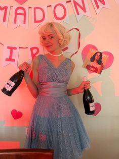 a woman holding two bottles of wine in front of a sign that says madonna friday