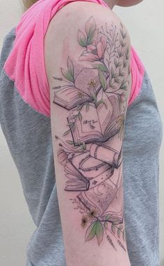 a woman with a tattoo on her arm has books and flowers in the middle of her arm