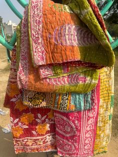 several colorful pieces of cloth hanging from a chair