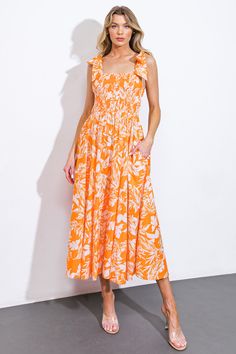 Experience the luxurious elegance of our printed woven midi dress. With a straight neckline, delicate shoulder ties, and a smocked bodice, this dress is both sophisticated and stylish. The full skirt adds volume and movement, making it perfect for any occasion.Details:Self : 100% CottonLining : 100% PolyesterSize & Fit- Model is 5`8" And Wearing Size Small- Measurements Taken From Size Small- Approx. Length: 50" Spring Midi Dress With Smocked Bodice, Spring Midi Dress With Smocked Bodice And Straight Neckline, Brunch Midi Dress With Smocked Bodice And Straight Neckline, Spring Maxi Dress With Smocked Bodice And Straight Neckline, Vacation Midi Dress With Smocked Back And Straight Neckline, Sleeveless Orange Midi Dress With Floral Print, Orange Sleeveless Printed Midi Dress, Orange Printed Sleeveless Midi Dress, Summer Orange V-neck Midi Dress