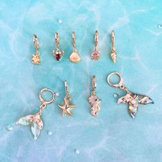 Dive into the depths of style with our sea creatures earrings collection, featuring enchanting mermaid earrings, stylish hoop earrings, and a versatile ear piercing set. These earrings are a perfect addition to any girl's birthday gift, ideal for mermaid-themed parties or sea creatures-themed gatherings. Explore the enchantment of the ocean with our shell earrings, starfish earrings, sea horse earrings, and jellyfish earrings, bringing a touch of aquatic elegance to your accessory collection. 🌟 Ocean-inspired Dangle Charms Jewelry, Gold Ocean-inspired Jewelry With Dangling Charms, Ocean-inspired Gold Jewelry With Dangling Charms, Beach Jewelry With Charms In Ocean-inspired Style, Ocean-inspired Jewelry With Charms For Beach, Ocean-inspired Beach Jewelry With Charms, Charm Jewelry For Beach, Ocean-inspired Jewelry With Dangling Charms For Gifts, Beach Jewelry With Dangling Charms