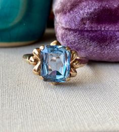 Beautiful blue topaz gemstone vintage ring. Mid-century; circa 1950s - 1970s.  Rectangular blue gemstone testing as a topaz on my gem tester measures approx 10 x 8 mm. Lovely and interesting mounting.  Signed 10K; yellow gold. Weighs 3.26 grams.  Ring size 9 US, resizable.  In very good used vintage condition. Pre-owned, light signs of wear/marks/age.  Add me to your Etsy favorites and see you on Instagram! @luxcharmjewelry - let's be jewelry friends xo 10k Gold Ring, Blue Topaz Gemstone, Etsy Favorites, Blue Gemstones, Topaz Gemstone, Vintage Ring, 10k Gold, Rings Statement, Beautiful Blue