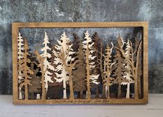 a wooden cutout of trees in the woods