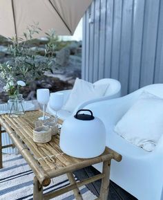 a white couch sitting on top of a wooden table