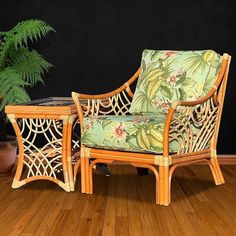 a chair and table sitting on top of a wooden floor next to a potted plant