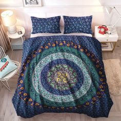 a bed covered in a blue and green comforter