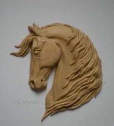 a brown horse head is shown on a white surface