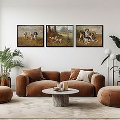 a living room with three paintings on the wall and two couches in front of them