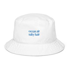 Surfer bucket hat, decorated with a subtle "Ocean Air Salty Hair" lettering as embroidery. This beach hat is perfect for surfers, ocean and beach lovers! Make a stylish and eco-friendly choice with the organic cotton twill bucket hat! This 100% cotton twill hat has the potential to become a favorite in your wardrobe thanks to its breathable material and simple look. This is how you can order: 1. 🎨 Choose your favorite color and size from the drop down menu. 2. 🛒 Choose the desired quantity. 3. Cotton Bucket Hat With Letter Print, Cotton Bucket Hat For Beach Season, One Size, Cotton Bucket Hat For Beach Season, Cotton Bucket Hat With Short Brim For Beach Season, Adjustable Bucket Hat With Letter Print For Beach, Cotton 5-panel Bucket Hat For Beach, Adjustable Letter Print Bucket Hat For Beach, Cotton 5-panel Bucket Hat For The Beach, Trendy Summer Bucket Hat With Embroidered Logo