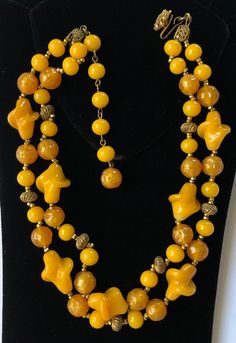 "Here is a beautiful vintage necklace by designer Miriam Haskell. The necklace is artfully crafted with two strands of sumptuous glass beads in rich butterscotch yellow and mustard yellow tones. The glistening beads are in an assortment of interesting shapes and size, with each bead spaced in-between pairs of tiny glinting gold tone seed beads, and at intervals in-between antiqued gold tone ribbed spacer beads. The necklace has a gilt filigree hook and an adjustable extension strand for closure. Miriam Haskell Necklace, Interesting Shapes, Miriam Haskell Jewelry, Yellow Necklace, Miriam Haskell, Vintage Necklaces, Yellow Tones, Red Rhinestone, Blue Rhinestones