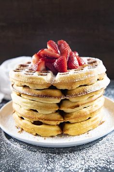 a stack of waffles with strawberries on top