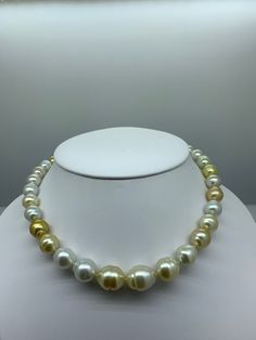 Genuine White and Gold South Sea Pearl Necklace. This hand knotted strand features 33 White and Gold South Sea Baroque Pearls AA+ High Luster the mixed colors range from platinum white, cream, champagne, and gold, the smallest pearl is 9.6 X 11.4 mm and the largest pearl is 14.2 X 17.2 mm. Guaranteed Genuine and Natural. These pearls are baroque shapes commonly found in South Seas with a few minor surface blemishes which is also common. The clasp is a 14K yellow gold Florentine 10 mm bead clasp. South Sea Pearl Necklace, Keshi Pearl Necklace, Corpus Christi Tx, Gold Pearl Necklace, Sea Pearl, Keshi Pearls, South Seas, South Sea Pearls, Dark Gold