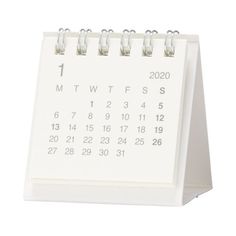 a white desk calendar sitting on top of a table