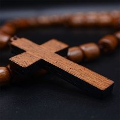 ♥ SOLID WOOD ROSARY - Solid, genuine brown jatoba wood rosary necklace with cross crucifix ♥ BEADED - 9 x 8 Solid Brown Jatoba Oval Shape Beads. ♥ NECKLACE FOR MEN - Can be used around neck or for praying. ♥ LENGHT - 19.5 inches. ♥ HANDCRAFTED - Made in Brazil by artisans with love and devotion. WARNING: CHOKING HAZARD -- Small parts. Not for children under 3 yrs. Brown Crucifix Necklace In Spiritual Style, Spiritual Brown Crucifix Necklace, Spiritual Brown Cross Necklace, Brown Wooden Beads Cross Necklace, Brown Cross-shaped Rosary With Wooden Beads, Brown Wooden Beaded Cross Rosary, Brown Cross Rosary In Spiritual Style, Brown Cross Necklace With Wooden Beads, Brown Spiritual Rosary With Cross