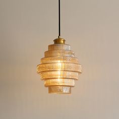 a chandelier hanging from a ceiling in a room with white walls and flooring