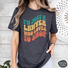 🔹This cute, trendy t-shirt is the perfect gift for any Lawyer who loves to shop. Featuring the popular "wavy" text graphic, this tee is both stylish and comfortable. It's perfect for a casual setting, and any Attorney who loves shopping would love to wear. 🔹These shirts are made of high-quality cotton and come in various sizes and colors. If you have any questions or requests, please feel free to contact us. We hope you enjoy browsing our shop and find something you love! 🔹This classic unisex jersey short sleeve tee fits like a well-loved favorite. Soft cotton and quality print make users fall in love with it over and over again. These t-shirts have-ribbed knit collars to bolster shaping. The shoulders are tapered for a better fit over time. Dual side seams hold the garment's shape for Wavy Text, Text Graphic, Love To Shop, Law School, Trendy Tshirts, Jersey Shorts, Shirt Shop, Ribbed Knit, Short Sleeve Tee