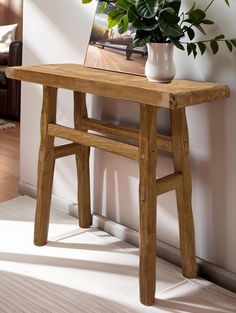 a wooden table with a potted plant on it