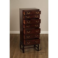 a tall wooden dresser sitting on top of a hard wood floor