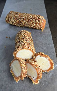 some kind of food that is sitting on a piece of wax paper with sesame seeds