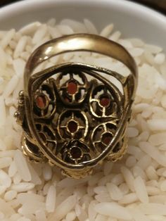 This is the last ring in a set of 5, that I bought in southern Indiana. It's a remarkable Huge 14K ladies Garnet Cluster ring. It weighs a hefty 11.0 grams, and the top measures 24mmx22m. There are 7-6x4mm medium red oval Garnets set with 6 prongs each. There a beaded pattern around each Garnet, and has a scrolled heart design on each side. There are some very fine scratches on a few stones that are considered normal for everyday wear. Its not noticeable unless looking under a 10x loupe. It's a Antique Oval Multi-stone Ring, Antique Gold Cluster Ring With Gemstones, Antique Round Enamel Ring, Victorian Cluster Ring With Multi-stone, Antique Gold Cluster Ring With Multi-stone, Victorian Multi-stone Cluster Ring, Antique Collectible Enamel Ring, Antique Multi-stone Cluster Ring, Vintage Gold Multi-stone Cluster Ring