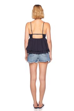 meet our cotton voile string v top, our must-have for the summer season. this top is designed from a lightweight cotton fabric making it a breeze to spend a hot day outside and forms a flattering fit with adjustable spaghetti straps. pair it with a denim bottom and sandals for the perfect beach day! deep v-neck adjustable spaghetti straps seaming below bust cutout detail at mid back layered hem 100% cotton machine wash cold, follow care instruction length 3" from the waist made in the USA model Chic Cotton V-neck Halter Top, Chic Halter Top With Spaghetti Straps For Vacation, Beach Tank Top With Spaghetti Tie Straps, Vacation Halter Top With Adjustable Spaghetti Straps, Halter Top With Spaghetti Straps For Vacation, Vacation Halter Top With Spaghetti Straps, Triangle Top With Built-in Bra For Day Out, Cotton Camisole With Built-in Bra For Vacation, Summer Vacation Halter Top With Tie Straps