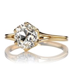 a fancy ring with a large diamond in the center and two thin bands around it