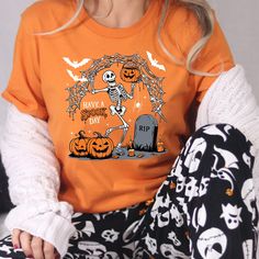 Have a spooky day t-shirt, Halloween Shirt, Witch Tshirt, Gift For Halloween, iprintasty halloween, Skeleton Fall Halloween Welcome to NoordesignBySelin!🌟 Thank you for visiting our shop! We hope you find something that adds a little extra warmth and beauty to your day. 😊 Happy Shopping! 🛒 📢 Important Details: Check All Photos: Review all images for product details. 📸 Choose Size & Color: Select your T-shirt size from the drop-down list next to the item picture. For color options, refer to Funny Halloween T-shirt With Character Print, Halloween Novelty T-shirt With Graphic Print, Spooky Halloween T-shirt With Graphic Print, Halloween Novelty T-shirt For Streetwear, Novelty Halloween T-shirt For Streetwear, Orange Halloween T-shirt With Letter Print, Halloween Funny Print Graphic T-shirt, Halloween Graphic Tee With Funny Print, Funny Halloween Character Print T-shirt