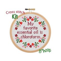 the cross stitch kit has been designed to look like a wreath with flowers and words on it