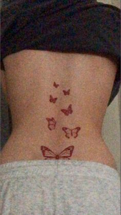 the back of a woman's stomach with butterflies drawn on her lower body and side