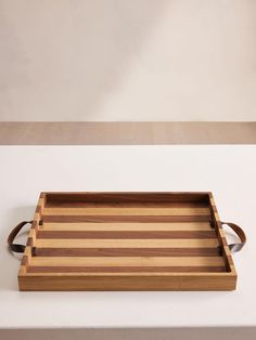 a wooden tray sitting on top of a white counter