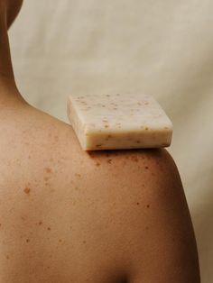 a close up of a person's back with a bar of soap on it