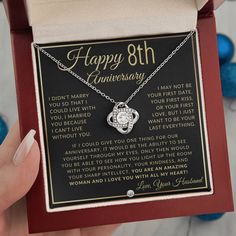 a woman's hand holding a necklace with an anniversary message on it