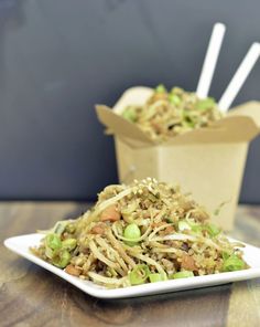 there is noodle salad on the plate with chopsticks