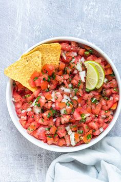 a white bowl filled with salsa and tortilla chips