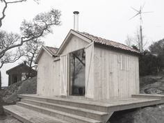 a small wooden house sitting on top of a hill