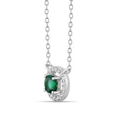 Captivate her attention with this astonishing fashion necklace. Crafted in sterling silver, this choice showcases a 5.0mm verdant-green emerald centered in an open shimmering lab-created white sapphire-lined frame. Bezel-set lab-created white sapphire stations adorn the chain to complete the look. Polished to a bright shine, this design suspends centered along an 18.0-inch cable chain with a 2.0-inch extender that secures with a lobster claw clasp. Formal Emerald Necklace With Round Pendant, Silver Necklace For Anniversary With May Birthstone, Silver Necklace For May Birthstone Anniversary, Formal Emerald Necklace With Halo Setting, Silver Emerald Necklace As Birthstone, Elegant Silver Necklace With May Birthstone, May Birthstone Emerald Necklace With Halo Setting, Green Emerald Necklace With Halo Setting For May Birthstone, Elegant Silver May Birthstone Necklace